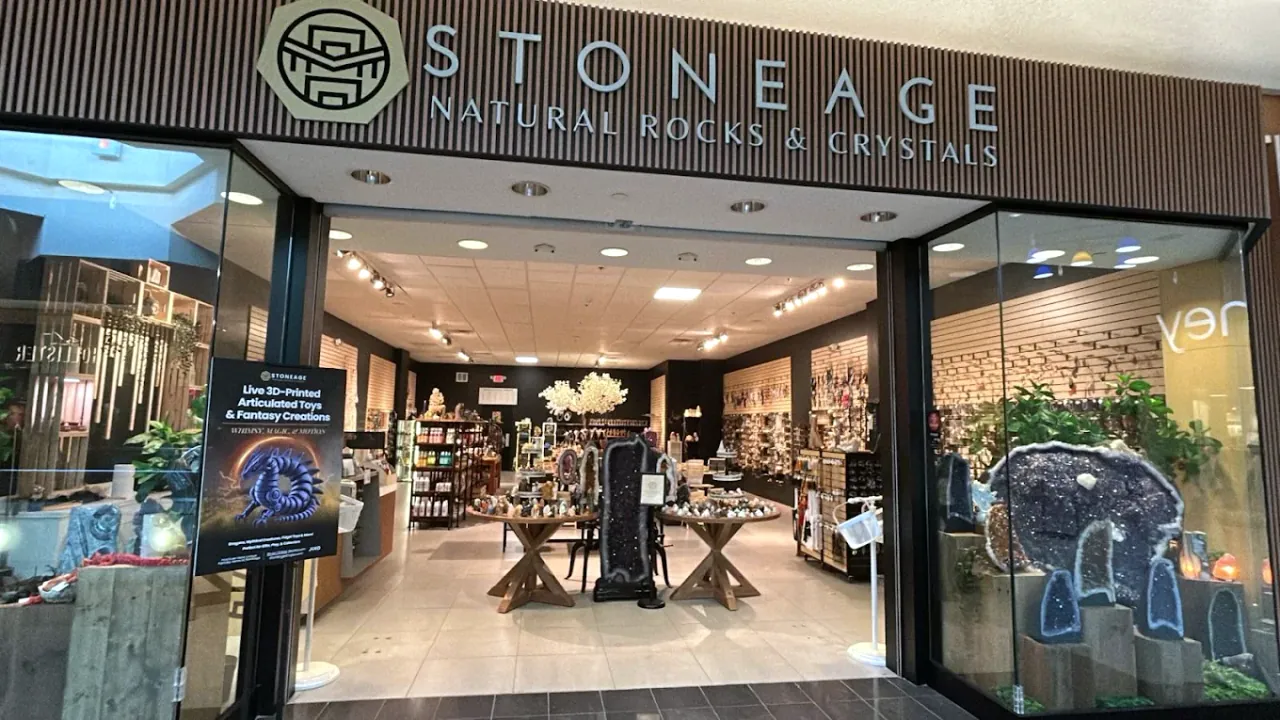 The Hanes Mall storefront, gold Stoneage wordmark above the entrance on the mall concourse
